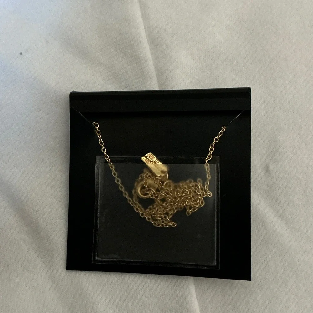 COACH Gold-Tone Multi-Ring Pendant Necklace with White Enamel